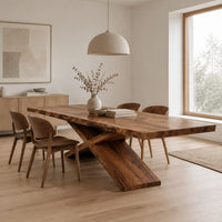 Dining table with crossed legs and a thick rectangular top in a Scandinavian dining room with white walls