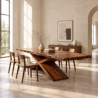Dining table with crossed legs and a thick rectangular top in a bright open plan dining room