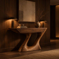 Console table with an angular two panel top on a sculpted z base in an evening entryway with walnut wall paneling