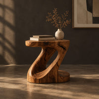 Z shaped side table with a carved diagonal opening and wide base, three-quarter view showing the grain