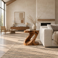 Z shaped side table with a carved diagonal opening and wide base in a bright open plan living room