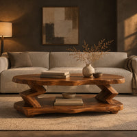 Oval coffee table with zigzag supports and a wavy edged lower shelf in a dark living room at golden hour