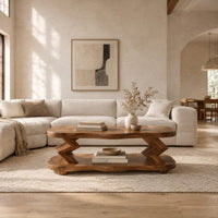 Oval coffee table with zigzag supports and a wavy edged lower shelf in a bright open plan living room