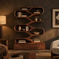 Zigzag bookshelf of stacked open oval loops on a wide base in a dark living room at golden hour