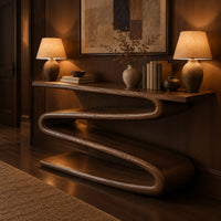 Console table with a continuous zigzag ribbon base and a flat slab top in an evening entryway with walnut wall paneling