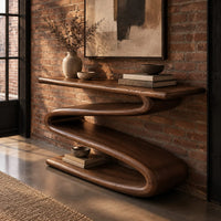 Console table with a continuous zigzag ribbon base and a flat slab top in an industrial loft entryway with exposed brick