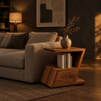 Zigzag side table with an angled top, open niche and slanted lower box in a dark living room at golden hour