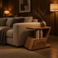 Zigzag side table with an angled top, open niche and slanted lower box in an evening living room with walnut wall paneling