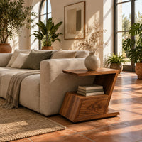 Zigzag side table with an angled top, open niche and slanted lower box in a bright living room with arched windows and plants